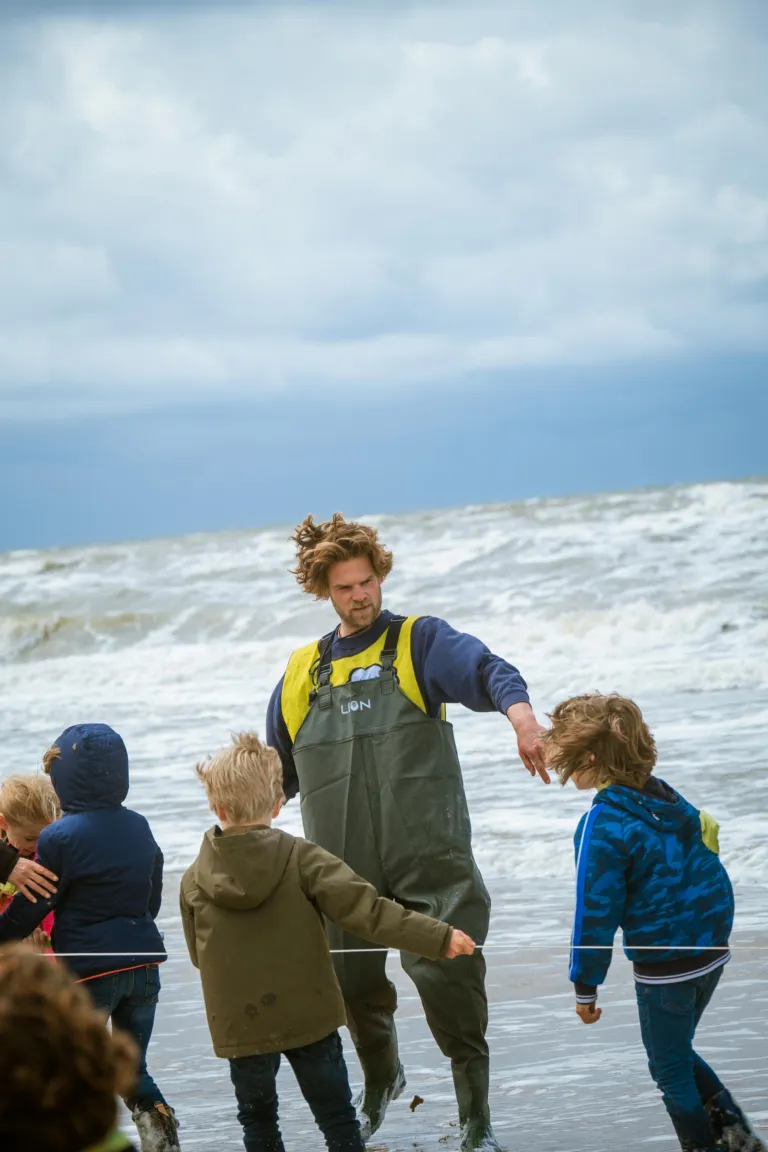 Kids and a supervisor on the beach in Noordwijk